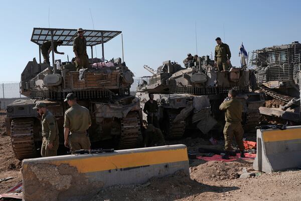 Israeli soldiers work in a staging area on the Israel-Gaza border after returning from the Gaza Strip, Saturday, Jan. 18, 2025, a day ahead of a ceasefire between Israel and Hamas. (AP Photo/Tsafrir Abayov)