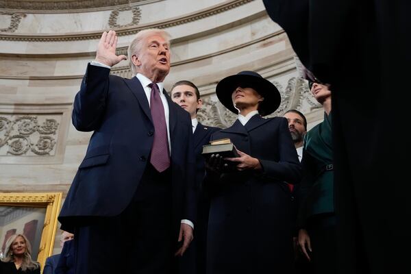 Donald Trump is sworn in as the 47th president of the United States by Chief Justice John Roberts as Melania Trump holds the Bible during the 60th Presidential Inauguration in the Rotunda of the U.S. Capitol in Washington, Monday, Jan. 20, 2025. (AP Photo/Morry Gash, Pool)