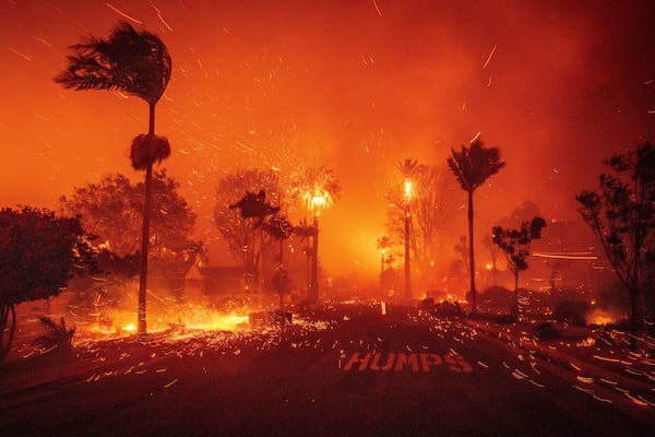 The Palisades Fire ravages a neighborhood amid high winds in the Pacific Palisades neighborhood of Los Angeles, Jan. 7, 2025. (AP Photo/Ethan Swope)