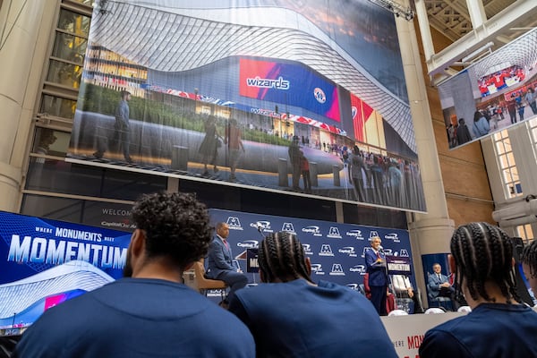 Members of the Washington Wizards NBA Basketball team listen as Ted Leonsis, owner of the Washington Wizards NBA basketball team and Washington Capitals NHL hockey team, speaks during an event announcing the start of work on a new Capital One Arena Gallery Place Atrium, Thursday, Dec. 19, 2024, in Washington. (AP Photo/Jacquelyn Martin)