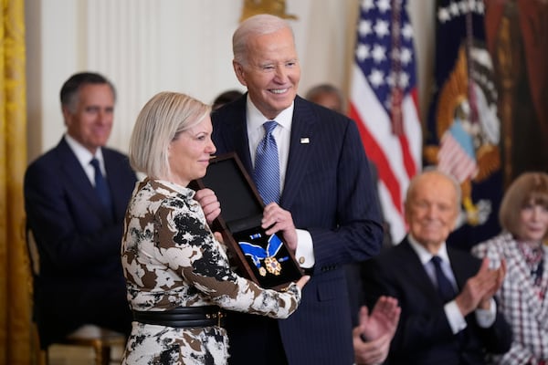 President Joe Biden, right, posthumously presents the Presidential Medal of Freedom, the Nation's highest civilian honor, to Stephanie Carter, left, on behalf of her late husband former Defense Secretary Ash Carter, in the East Room of the White House, Saturday, Jan. 4, 2025, in Washington. (AP Photo/Manuel Balce Ceneta)