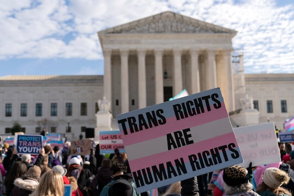 FILE - Transgenders rights supporters rally outside of the Supreme Court, Wednesday, Dec. 4, 2024, in Washington. (AP Photo/Jose Luis Magana, File)