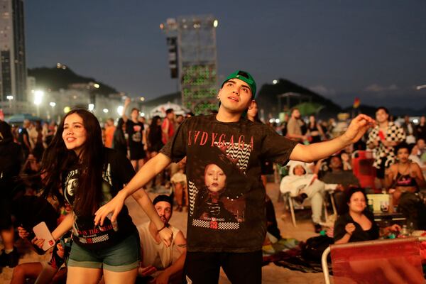 Fans wait for the start of Lady Gaga's free concert on Copacabana beach in Rio de Janeiro, Saturday, May 3, 2025. (AP Photo/Bruna Prado)