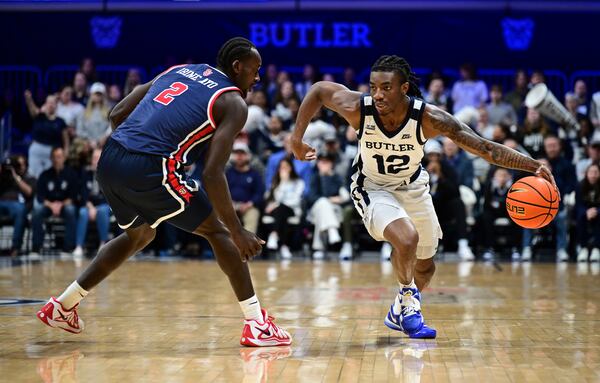 Butler guard Kolby King (12) looks to get the ball down court around St. John's forward Sadiku Ibine Ayo (2)during the first half of an NCAA college basketball game, Wednesday, Feb. 26, 2025, in Indianapolis, Ind. (AP Photo/Marc Lebryk)