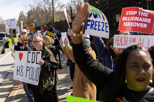 Demonstrators protest the mass firing of 1,000 Centers for Disease Control and Prevention (CDC) employees in front of the CDC headquarters in Atlanta on Tuesday, Feb. 18, 2025. (Arvin Temkar/Atlanta Journal-Constitution via AP)