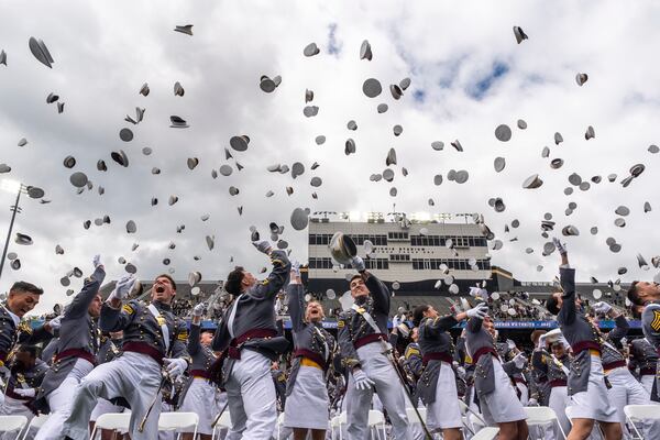United States Military Academy graduating cadets throw their hats in the air at the end of commencement ceremonies in West Point, N.Y., Saturday, May 24, 2025. (AP Photo/Adam Gray)