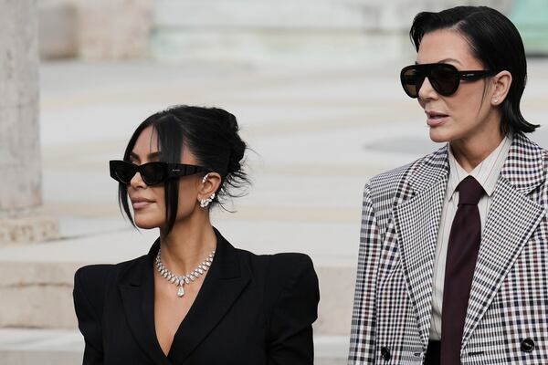 Kim Kardashian, left, accompanied by her mother Kris Jenner leaves the justice palace after testifying, regarding a robbery of millions of dollars in jewels from her Paris hotel room in 2016, in Paris, Tuesday, May 13, 2025. (AP Photo/Aurelien Morissard)