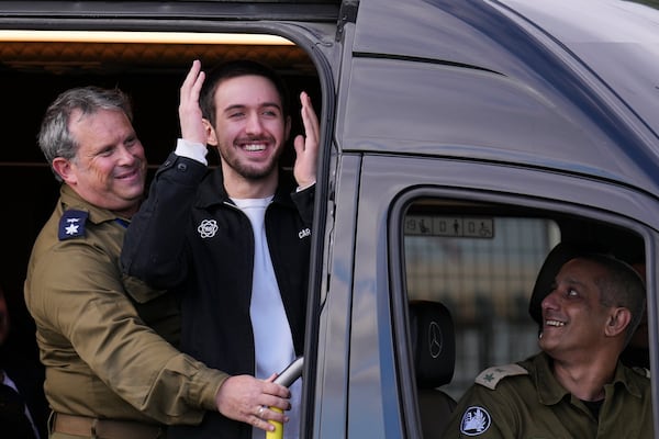 Freed Israeli hostage Omer Shem Tov looks on from a van as he arrives at Beilinson hospital in Petah Tikva, Israel, after he was released from Hamas captivity in the Gaza Strip, Saturday, Feb. 22, 2025. (AP Photo/Ariel Schalit)