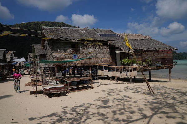 A villager walks in Moken village at Surin Islands in Phang Nga Province Thailand, Wednesday, Dec. 11, 2024. (AP Photo/Sakchai Lalit)