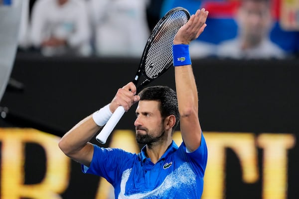 Novak Djokovic of Serbia celebrates after defeating Jaime Faria of Portugal in their second round match at the Australian Open tennis championship in Melbourne, Australia, Wednesday, Jan. 15, 2025. (AP Photo/Vincent Thian)