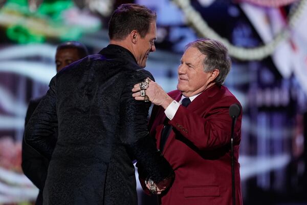 Coach Bill Belichick hugs and presents the AP Coach of the year award to Minnesota Vikings coach Kevin O'Connell during the NFL Honors award show ahead of the Super Bowl 59 football game, Thursday, Feb. 6, 2025, in New Orleans. (AP Photo/David J. Phillip)