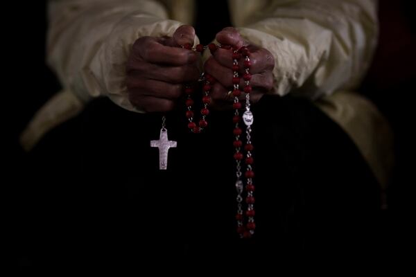 A Catholic woman attends a nightly rosary prayer service for the health of Pope Francis in St. Peter's Square at the Vatican, Wednesday, Feb. 26, 2025. (AP Photo/Bernat Armangue)