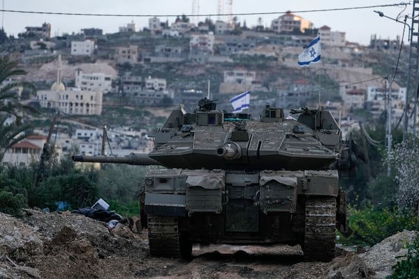 An Israeli tank drives towards the occupied West Bank of Jenin camp, Sunday, Feb. 23, 2025. (AP Photo/Majdi Mohammed)