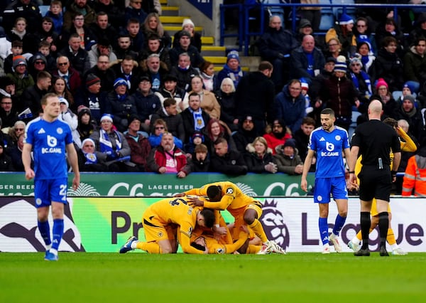 Wolverhampton Wanderers' Goncalo Guedes celebrates scoring his side's first goal of the game with teammates, during the English Premier League soccer match between Leicester City and Wolverhampton Wanderers at King Power Stadium, in Leicester, England, Sunday, Dec. 22, 2024. (Mike Egerton/PA via AP)