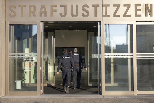 Police officers enter the special appeals court building in which ex-FIFA president Sepp Blatter and Michel Platini, former UEFA president and FIFA vice president, are facing a second trial in Muttenz, Switzerland, Monday, March 3, 2025. (Urs Flueeler/Keystone via AP)