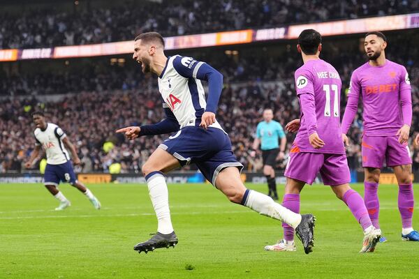 Tottenham Hotspur's Rodrigo Bentancur, front, celebrates after scoring his side's first goal during the English Premier League soccer match between Tottenham Hotspur and Wolverhampton Wanderers in London, England, Sunday, Dec. 29, 2024. (John Walton/PA via AP)