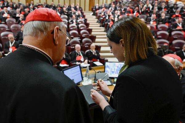A Vatican employee annulls the papal seal on the pope's fisherman's ring, at the Vatican, Tuesday, May 6, 2025. (Vatican Media via AP)