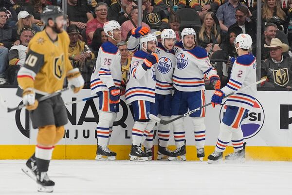 Edmonton Oilers right wing Vasily Podkolzin (92) celebrates with teammates after scoring against the Vegas Golden Knights during the second period of Game 2 of a second-round NHL hockey playoff series Thursday, May 8, 2025, in Las Vegas. (AP Photo/John Locher)