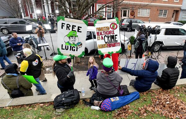 Supporters of Luigi Nicholas Mangione, who is being charged with the murder of UnitedHealthcare CEO Brian Thompson, gather at the front of Blair County Courthouse for the suspect's preliminary and extradition hearing in Hollidaysburg, Pa., Thursday, Dec. 19, 2024. (Thomas Slusser/The Tribune-Democrat via AP)