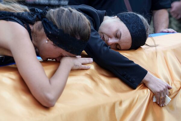 FILE - Relatives cry over the coffin of a Ukrainian serviceman killed in a Russian rocket attack at a Ukrainian military academy, during his funeral ceremony in Poltava, Ukraine, Saturday Sept. 7, 2024. (AP Photo/Evgeniy Maloletka, File)