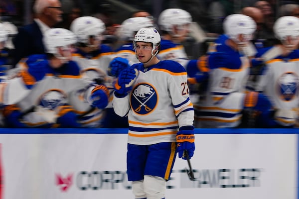 Buffalo Sabres' Jack Quinn (22) celebrates with teammates after scoring a goal during the second period of an NHL hockey game against the New York Islanders Monday, Dec. 23, 2024, in Elmont, N.Y. (AP Photo/Frank Franklin II)