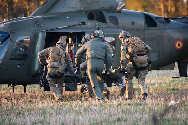 FILE - Soldiers from the Belgian Special Forces perform a mock medical evacuation during an European Defense Agency joint military training exercise at Florennes airbase in Rosse, Belgium on Nov. 30, 2016. (AP Photo/Virginia Mayo, File)