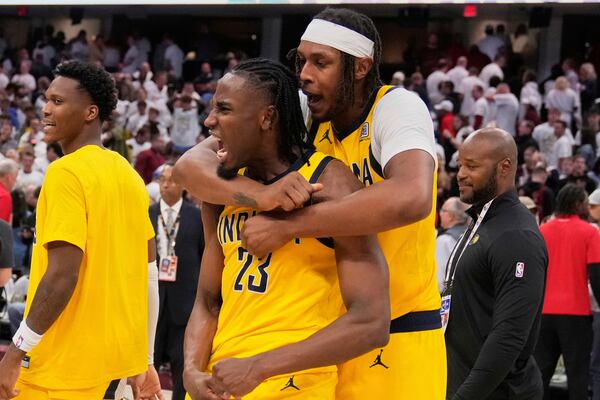 Indiana Pacers forward Aaron Nesmith (23) and center Myles Turner, right, celebrate after the Pacers defeated the Cleveland Cavaliers in Game 2 in the Eastern Conference semifinals of the NBA basketball playoffs Tuesday, May 6, 2025, in Cleveland. (AP Photo/Sue Ogrocki)