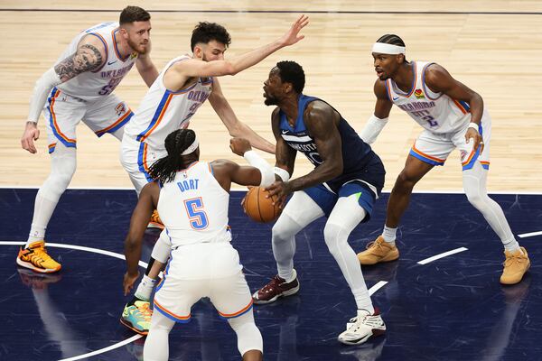 Minnesota Timberwolves forward Julius Randle (30) controls the ball against Oklahoma City Thunder defenders during the first half of Game 3 of the Western Conference finals of the NBA basketball playoffs, Saturday, May 24, 2025, in Minneapolis. (AP Photo/Matt Krohn)