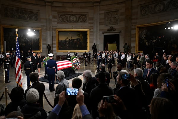 President elect Donald Trump and his wife Melania Trump visit the flag draped casket of the late former President Jimmy Carter as he lies in state at the Rotunda of the U.S. Capitol on Wednesday, Jan. 8, 2025, in Washington. (AP Photo/John McDonnell)