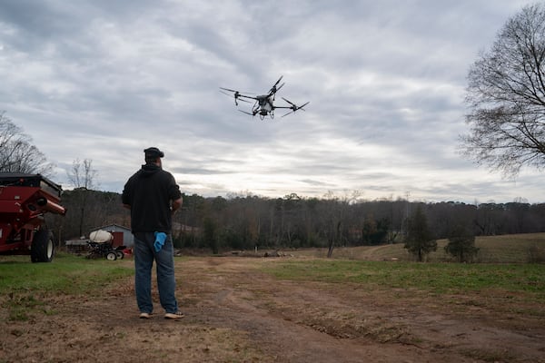 Russell Hedrick uses a DJI drone to put crop cover on his farm, Tuesday, Dec. 17, 2024, in Hickory, N.C. (AP Photo/Allison Joyce)