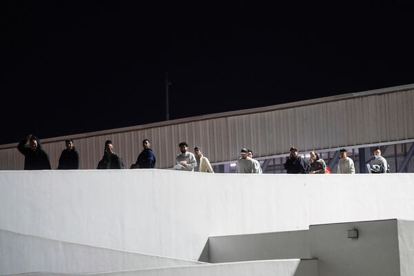 FILE - Migrants walk into Mexico after being deported from the U.S., at El Chaparral pedestrian border bridge in Tijuana, Mexico, Jan. 21, 2025. (AP Photo/Felix Marquez, File)