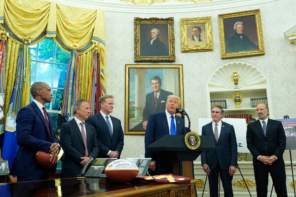President Donald Trump, third from right, speaks as Commerce Secretary Howard Lutnick, from right, Interior Secretary Doug Burgum, and from left, Secretary of Housing and Urban Development Scott Turner, Washington Commanders owner Josh Harris and NFL Commissioner Roger Goodell listen during an event to announce that the 2027 NFL Draft will be held on the National Mall, in the Oval Office of the White House, Monday, May 5, 2025, in Washington. (AP Photo/Alex Brandon)