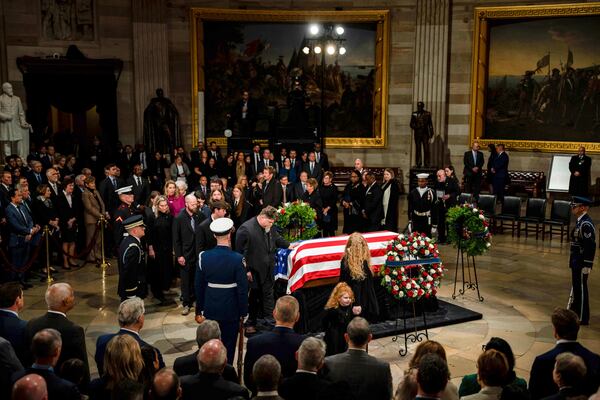 The Carter family pay their respects during a ceremony as the flag-draped casket of former President Jimmy Carter lies in state, at the Capitol, Tuesday, Jan. 7, 2025, in Washington. Carter died Dec. 29 at the age of 100. (Kent Nishimura/The New York Times via AP, Pool)