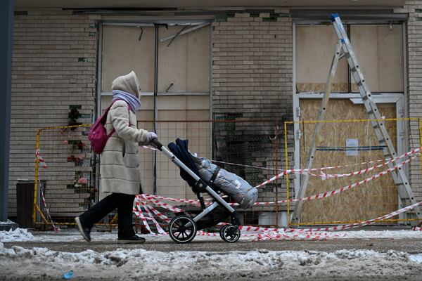 A person walks past a residential apartment's block in Moscow, Russia, Wednesday, Dec. 18, 2024, where Lt. General Igor Kirillov, the head of Russia's Nuclear, Biological, and Chemical Defence Forces and his assistant Ilya Polikarpov were killed by an explosive device. (AP Photo/Dmitry Serebryakov)