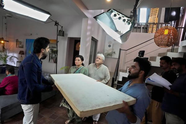 Pakistani actor and producer Khalid Anam, center, performs with Saad Qureshi, left, Shaheen Khan, second left, during the shooting of a scene of tv drama serial 'Aik Lafz Mohabbat' or 'One Word Love' in Karachi, Pakistan, Monday, Nov. 11, 2024. (AP Photo/Fareed Khan)