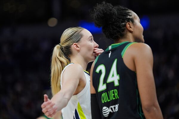 Dallas Wings guard Paige Bueckers (5) and Minnesota Lynx forward Napheesa Collier (24) talk during the second half of a WNBA basketball game Wednesday, May 21, 2025, in Minneapolis. (AP Photo/Abbie Parr)