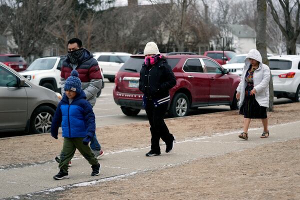 People arrive at St. Mary's Catholic Church to celebrate the feast day of Guatemala's Black Christ of Esquipulas in Worthington, Minnesota, Sunday, Jan. 12, 2025. (AP Photo/Abbie Parr)