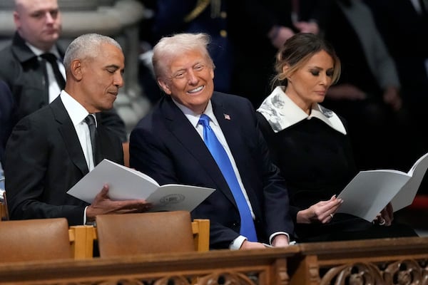 Former President Barack Obama talks with President-elect Donald Trump, next to Melania Trump, as they arrive to attend the state funeral for former President Jimmy Carter at Washington National Cathedral in Washington, Thursday, Jan. 9, 2025. (AP Photo/Ben Curtis)