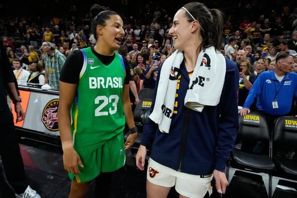 Brazil guard Izabela Leite (23) talks with Indiana Fever guard Caitlin Clark, center right, after an exhibition women's basketball game, Sunday, May 4, 2025, in Iowa City, Iowa. (AP Photo/Charlie Neibergall)