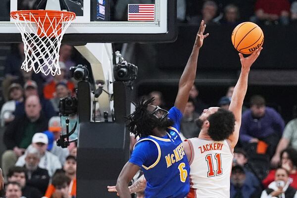 McNeese State guard Javohn Garcia (6) stretches for a block against Clemson guard Jaeden Zackery (11) during the first half in the first round of the NCAA college basketball tournament, Thursday, March 20, 2025, in Providence, R.I. (AP Photo/Charles Krupa)