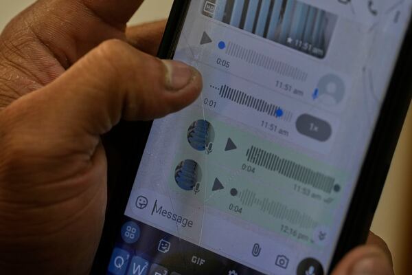 A Rohingya refugee who has not been identified due to safety concerns, shows his conversation details on WhatsApp with his family members in Myanmar as he talks to The Associated Press in New Delhi, India, Friday, May 16, 2025. (AP Photo/Manish Swarup)