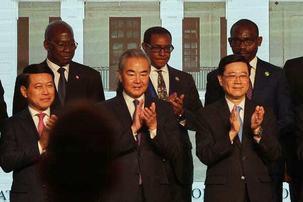Chinese Foreign Minister Wang Yi, center, attends the signing ceremony of “the Convention on the Establishment of the International Organization for Mediation”, in Hong Kong, Friday, May 30, 2025. (AP Photo/Jonathan Lee)