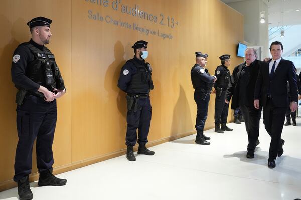 Actor Gerard Depardieu, second right,, arrives at his trial for the alleged sexual assaults of two women on a film set in 2021, with his lawyer Jeremie Assous, right,Tuesday, March 25, 2025 in Paris. (AP Photo/Aurelien Morissard)