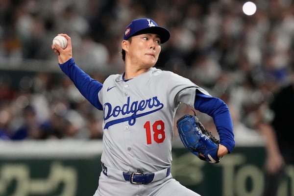 Los Angeles Dodgers starting pitcher Yoshinobu Yamamoto throws to the Chicago Cubs in the first inning of an MLB Japan Series baseball game in Tokyo, Japan, Tuesday, March 18, 2025. (AP Photo/Eugene Hoshiko)