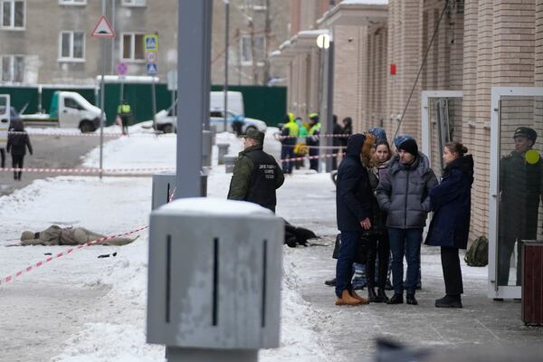 Investigators work at the place where Lt. General Igor Kirillov, the head of Russia's Nuclear, Biological, and Chemical Defence Forces and his assistant, seen at left, were killed by an explosive device planted close to a residential apartment's block in Moscow, Russia, Tuesday, Dec. 17, 2024. (AP Photo)