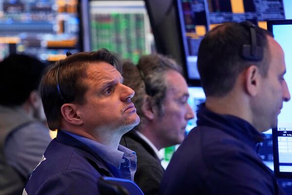 Trader Michael Milano, left, works with colleagues on the floor of the New York Stock Exchange, Tuesday, May 27, 2025. (AP Photo/Richard Drew)