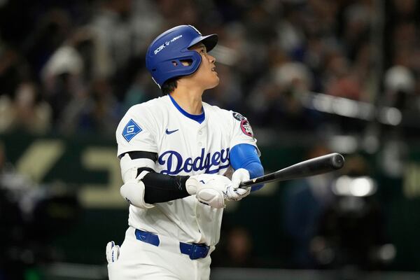 Los Angeles Dodgers' Shohei Ohtani follows through on a solo home run in the fifth inning of an MLB Tokyo Series baseball game against the Chicago Cubs in Tokyo, Japan, Wednesday, March 19, 2025. (AP Photo/Hiro Komae)