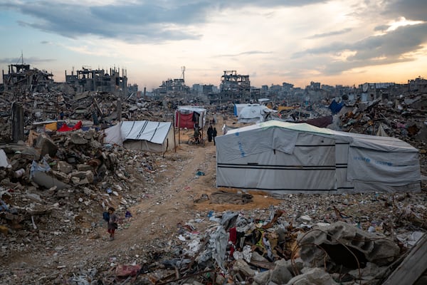 Palestinians walk in the destruction caused by the Israeli air and ground offensive in Jabaliya, Gaza Strip, Tuesday, Feb. 11, 2025. (AP Photo/Jehad Alshrafi)