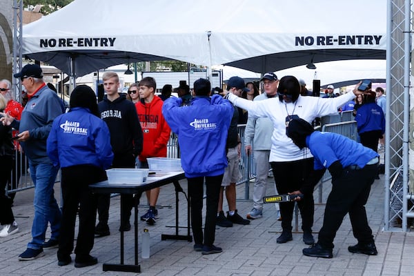 Fans pass through security check points as they enter the Ceasars Superdome fan zone ahead of the Sugar Bowl NCAA College Football Playoff game, Thursday, Jan. 2, 2025, in New Orleans. (AP Photo/Butch Dill)