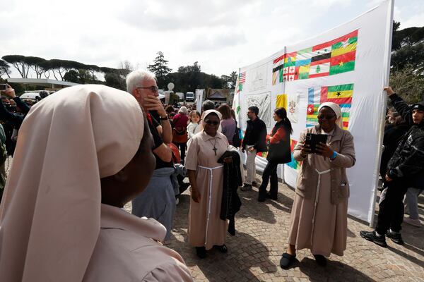 Faithfuls and nuns wait a Pope Francis appearing at a window of the Agostino Gemelli Polyclinic in Rome, Sunday, March 23, 2025, for the first time after being admitted on Feb. 14 with bronchitis that afterward worsened into bilateral pneumonia. (AP Photo/Riccardo De Luca)